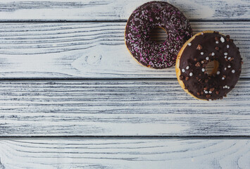 delicious donuts on a light wooden background