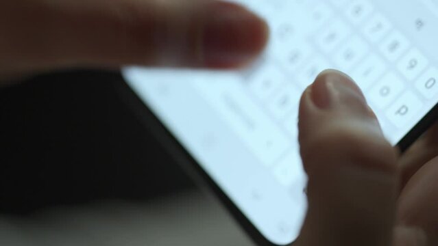 Female hands typing text on smartphone close-up