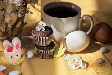 Easter concept with fresh  flowers and a cup of coffee on a table, close up, still life photography