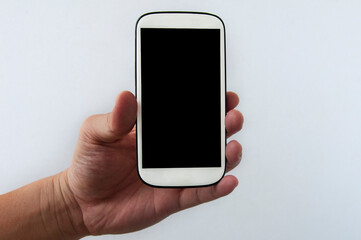 Hand holding white smartphone isolated on white background. Copy Space concept