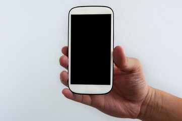 Hand holding white smartphone isolated on white background. Copy Space concept