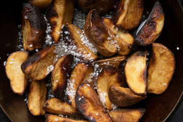 Delicious fried potatoes in a rustic way close-up, top view