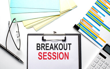 BREAKOUT SESSION text on the paper sheet with chart,color paper and calculator
