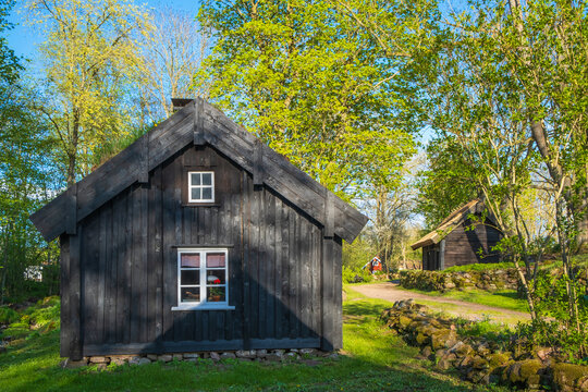 Old idyllisk black log cottage