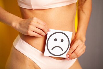 Woman health female body holding white card sad smile near stomach healthy