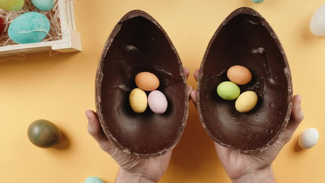 Opening chocolate easter egg with surprise