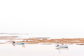 A small fishing boat on the beach in Jaffa, on a foggy day. Concept for peace, quiet and serenity....