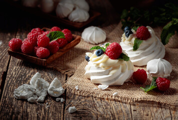 Dessert Pavlova with raspberries, blueberries and mint.