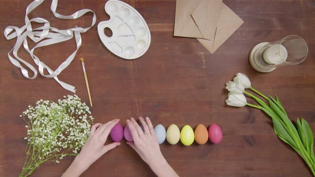 Top view of a table with items to create a composition for Easter. Women's hands arrange objects on the table. Church holiday-Easter