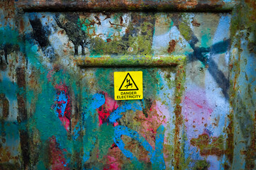 old painted wall with sign danger electricity 