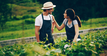 Fototapeta premium Gardening time is quality time. Shot of a happy young couple working in a garden together.