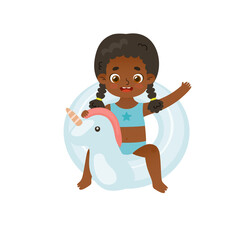 Happy african american kid on inflatable unicorn. Adorable baby girl swimming with rubber ring.