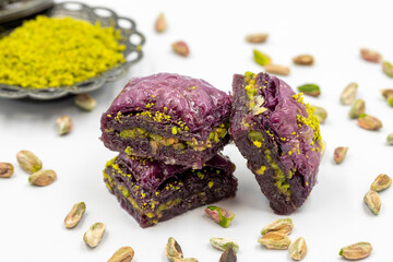 Pistachio purple baklava on a white background. Baklava specially prepared for diabetics. Traditional Mediterranean cuisine delicacies. close up