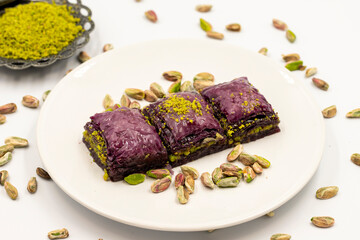 Pistachio purple baklava on a white background. Baklava specially prepared for diabetics. Traditional Mediterranean cuisine delicacies. close up