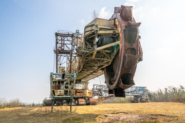 Fototapeta premium Bucket wheel excavators (BWEs) are colossal machines that represent the pinnacle of engineering for surface mining operations. They are designed to continuously remove vast quantities of overburden