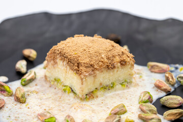 Cold baklava on a white background. Cold baklava prepared with milk and pistachio is very popular. Traditional Mediterranean cuisine delicacies. close-up cold baklava. local name soguk baklava