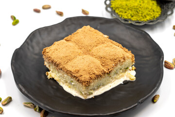 Cold baklava on a white background. Cold baklava prepared with milk and pistachio is very popular. Traditional Mediterranean cuisine delicacies. close-up cold baklava. local name soguk baklava