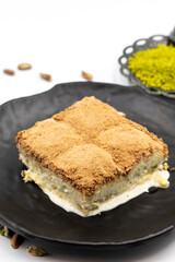 Cold baklava on a white background. Cold baklava prepared with milk and pistachio is very popular. Traditional Mediterranean cuisine delicacies. close-up cold baklava. local name soguk baklava