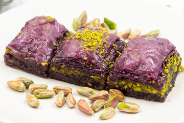 Pistachio purple baklava on a white background. Baklava specially prepared for diabetics. Traditional Mediterranean cuisine delicacies. close up baklava.