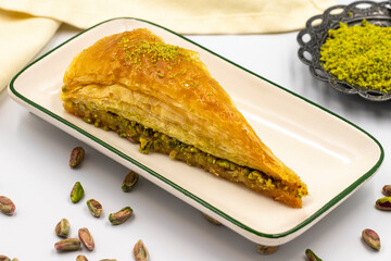Carrot slice baklava on a white background. Traditional Mediterranean cuisine delicacies. close-up pistachio baklava. Local name havuc dilim baklava