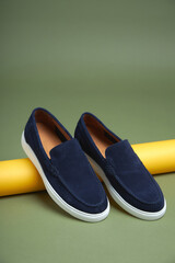 Fashion male blue shoes on green background. Fashion shoes made of eco-leather spring-summerr 2022.