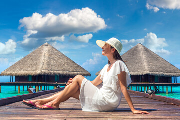 Woman sitting on the wooden pier