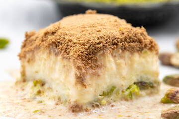 Cold baklava on a white background. Cold baklava prepared with milk and pistachio is very popular. Traditional Mediterranean cuisine delicacies. close-up cold baklava. local name soguk baklava