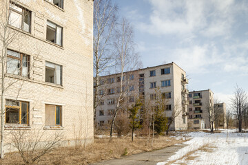 Abandoned white brick multistorey houses. Forgotten, abandoned ghost town Skrunda, Latvia. Former Soviet army radar station.