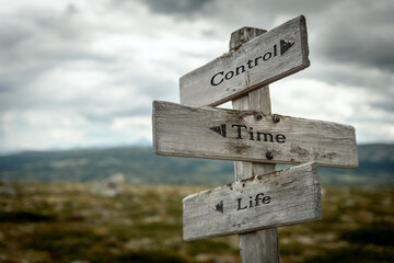 control time life text quote written in wooden signpost outdoors in nature. Moody theme feeling.