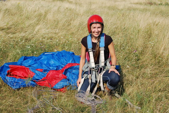 person with a parachute on the grass 