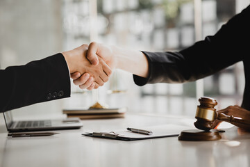 Lawyers shake hands with clients who come to testify in the case of embezzlement from business...