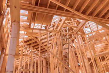 Wooden framing the wall of planks new residential house with construction site