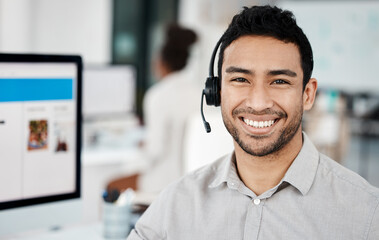 Success is liking yourself. Shot of a young businessman wearing a headset while working in an...