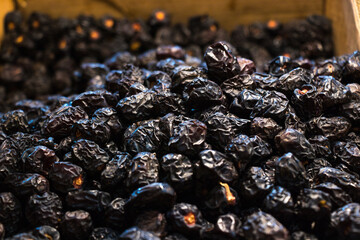 Ajwa dates. Dried dates, fruits of date palm. Fruit market selling ajwa dates for iftar