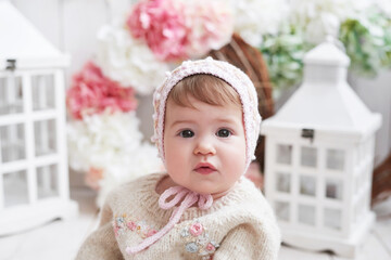 Baby girl in hat with wooden toys. Postcard Mother's Day and Easter. Children Protection Day. World Happiness Day. Smiling child