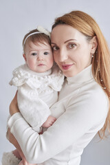 Baby girl in mother's arms. Postcard Mother's Day and Easter. Children Protection Day. World Happiness Day. Smiling child