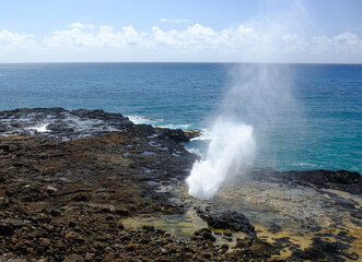 Fototapeta na wymiar Spout of water in lava rocks