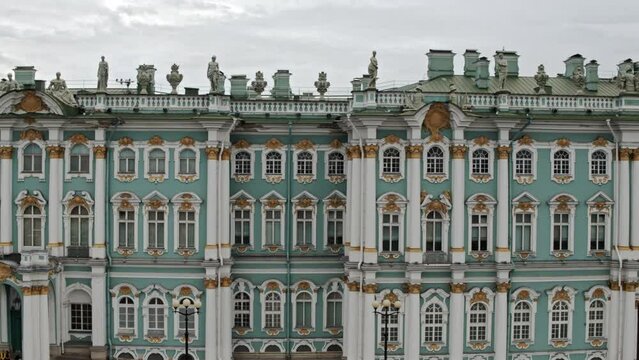 Drone view on facade of Hermitage museum with sculptures and columns.