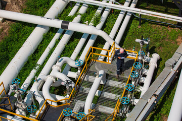 Top view male worker inspection at valve of visual check record pipeline oil