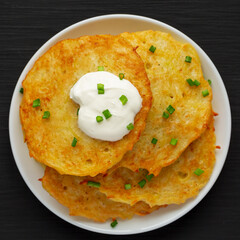 Homemade Boxty Irish Potato Pancakes on a Plate on a black background, top view. Flat lay, overhead, from above.
