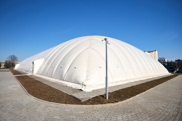 Inflatable air dome stadium. Inflated Tennis air dome or Tennis bubble arena. Modern urban...