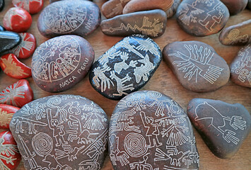 Heap of souvenirs of Nazca lines carved into the various size of pebble stones, Ica region, Peru,...