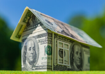 Cottage made of dollar banknotes, housing loan. Think green.