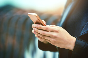 Instant communication. The number one form of communication. Cropped shot of a woman using a mobile phone in the city.