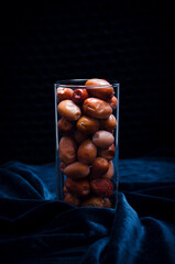 Dried fruits in a glass on a dark background. Stock photo - obrazy, fototapety, plakaty