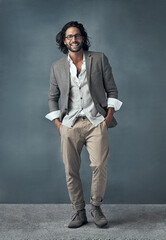 Positively charming. Full length studio portrait of a handsome and stylish young man against a grey background.