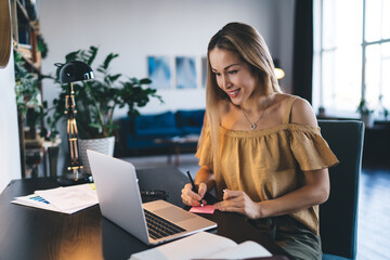 European girl learning online on laptop at home