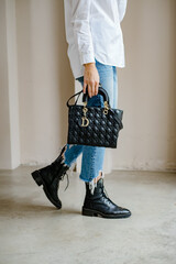 Trendy outfit woman with black bag. Girl with bag over his shoulder outdoors. Shoulder Bags for...