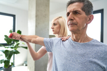 Senior caucasian man training with physical therapist