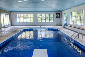 Large indoor pool with lots of natural light from large windows in an atrium
